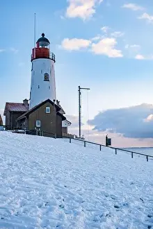 Landscape House Prints: Urk Netherlands lighthouse during winter with snow covered coastline