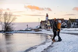 Urk Netherlands lighthouse during winter with snow covered coastline