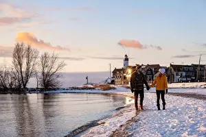 Ijsselmeer Prints: Urk Netherlands lighthouse during winter with snow covered coastline