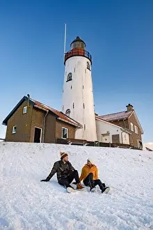 Urk Netherlands lighthouse during winter with snow covered coastline