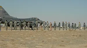 Brig Prints: U.S. Airmen with the 332nd Air Expeditionary Wing (AEW) salute Brig