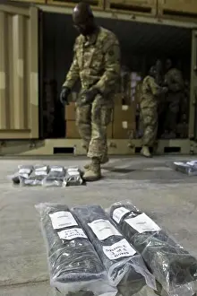 Accountability Prints: U.S. Army Soldiers layout and inspect equipment inside the Iraq Train and Equipment Fund (ITEF)