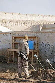 Americans Prints: A U.S. Marine urinates into a piss tube at a combat outpost in southern Afghanistan's Helmand Province