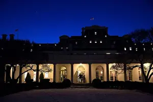 Politicians Prints: U.S. President Barack Obama walks along the Colonnade at night while heading to the White House Outer Oval Office