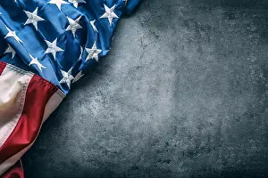 USA flag. American flag. American flag freely lying on concrete background. Close-up Studio shot. Toned Photo