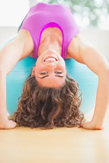 Curly Hair Prints: USA, New Jersey, Jersey City, Woman exercising on fitness ball
