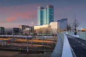 Utrecht, Netherlands cityscape over train station platforms at dawn