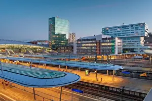 Utrecht, Netherlands cityscape over train station platforms at dawn