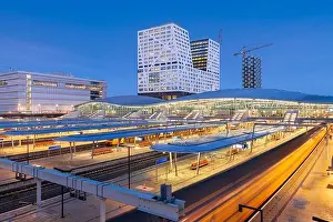 Utrecht, Netherlands cityscape over train station platforms at dawn
