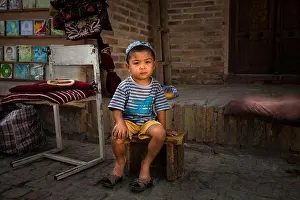 Little Boy Prints: Uzbekistan, Bukhara, little boy in front of his father's shop