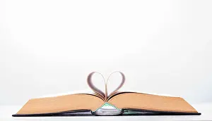 Valentines Prints: Valentine's day or reading concept with heart shaped book on white background