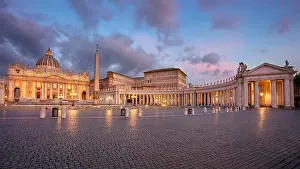 Vatican City, Rome, Italy. Cityscape image of illuminated Saint Peter's Basilica and St. Peter's Square, Vatican City, Rome, Italy at sunrise