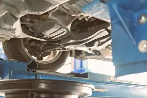 Changing Prints: vehicle lift up by hydraulic for motor oil change and transmission inspection
