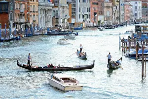 Venice, Italy - August 7, 2014: gondolas and boats on venetian Grand Canal