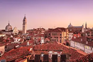 Venice, Italy rooftop skyline and historic landmarks at dusk