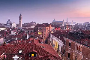 Venice, Italy rooftop skyline and historic landmarks at dusk