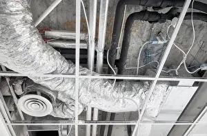 Ventilation Prints: Ventilation system with pipes in silver insulation material in suspended ceiling during renovation