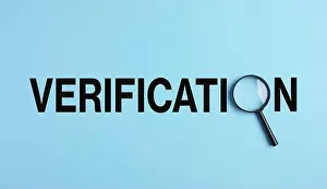Examine Prints: Verification word spelled out in black letters with magnifying glass on blue background analyzing text