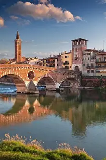 Verona, Italy. Cityscape image of beautiful Italian town Verona with the Stone Bridge over Adige River at sunset