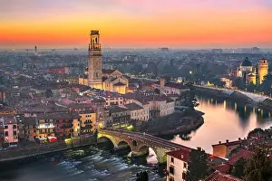 Verona, Italy town skyline on the Adige River at dusk