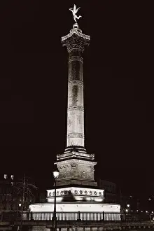 Grayscale Prints: A vertical grayscale of the Colonne de Juillet monument at Bastille palace at night in Paris