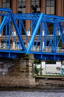 Rapids Prints: A vertical shot of a bright blue bridge in Downtown Grand Rapids