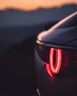 Backlight Prints: Vertical shot of a car red backlight