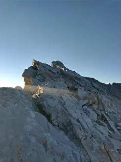 Traverse Prints: A vertical shot of mount Rundle Traverse under a blue sky in Alberta, Canada