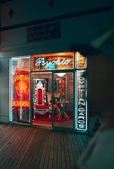 Adviser Prints: A vertical shot of neon signs lit at night at Boardwalk Empire