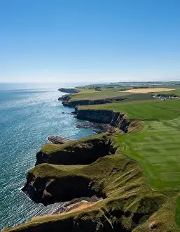 Clan Prints: A vertical view of the cliffs and fields on the wild and rugged North Sea shore of Aberdeenshire