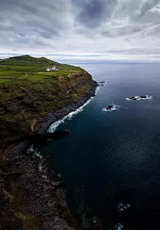 Vertorama / Panorama of a coastal region with lighthouse on Sao Miguel