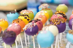 Sweet Tooth Prints: A vibrant array of colorful cake pops decorated with sprinkles and chocolate pieces