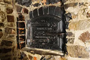 Architectural Feature Prints: Victorian cast iron bread oven in an inglenook fireplace in a cottage in North Devon (Exmoor) England