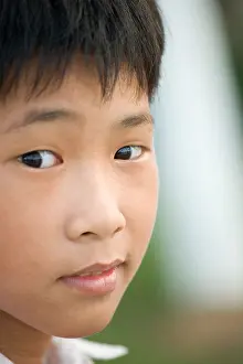 Glance Prints: Vietnamese boy with sly sideways glance, Danang, Vietnam