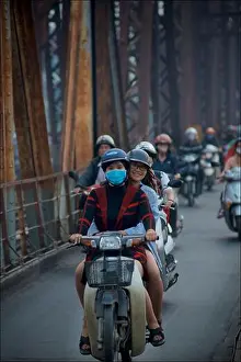Motorcycles Prints: Vietnamese city commuters on motorcycles crossing the historic Long Bien bridge