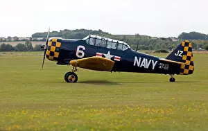 Taxiing Prints: Side view of a 1942, North American AT-6C Harvard IIA taxiing for take of
