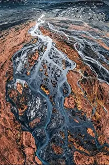 River Crossing Prints: Top view of abstract glacier rivers pattern flowing through volcanic lava field in Icelandic highlands on summer