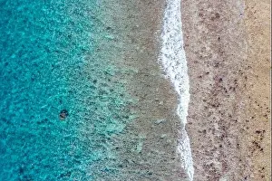 Top view aerial photo from flying drone. Beautiful beach. Aerial view of calm waves, breaking at coral reef. Exotic ocean beach, tropical landscape