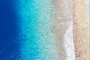 Top view aerial photo from flying drone. Beautiful beach. Aerial view of calm waves, breaking at coral reef. Exotic ocean beach, tropical landscape
