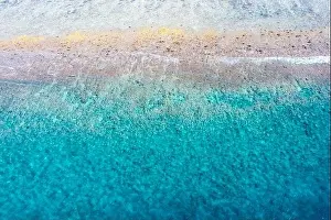 Top view aerial photo from flying drone. Beautiful beach. Aerial view of calm waves, breaking at coral reef. Exotic ocean beach, tropical landscape