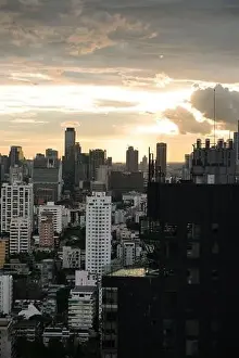 Sukhumvit Prints: View of the bangkok skyline at sunset from the Sukhumvit area on a sunny day, Thailand