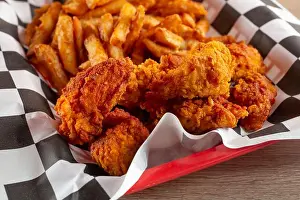 Potatoes Prints: A view of a basket of Nashville chicken tenders and french fries