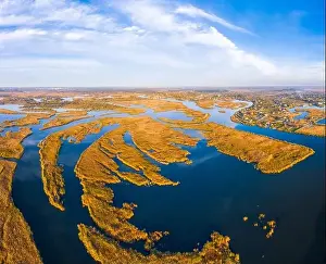 Dnepr Prints: Top view of the beautiful Samarskie Plavni on the Dnieper with a village nearby in the warm evening light