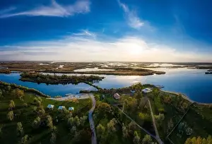 Dnepr Prints: Top view of the beautiful Samarskie Plavni on the Dnieper with a village nearby in the warm evening light