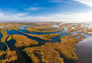 Dnepr Prints: Top view of the beautiful Samarskie Plavni on the Dnieper with a village nearby in the warm evening light