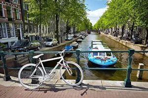 May Collection: View at bicycle and canal - Amsterdam, Holland Netherlands