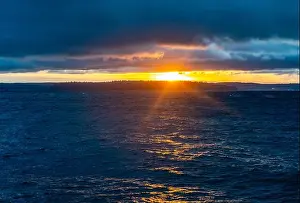 Washington State Prints: A view of a brigbht sunset across the Puget Sound from West Seattle, Washington