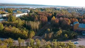 Top view of city on background of river and autumn forest