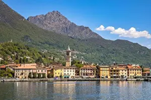 View of city of Porlezza on the shore of lake Lugano With the Alps in the background seen from lake