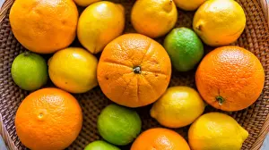 Oranges Prints: Above view close up of a fruit basket on a table with mandarins and a melon